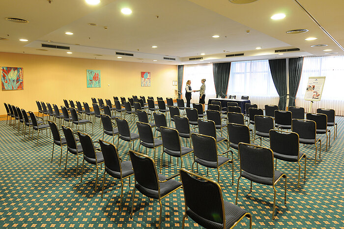 Grande salle de conférence avec sièges en rangée et installation professionnelle au Maritim Hotel Magdeburg.