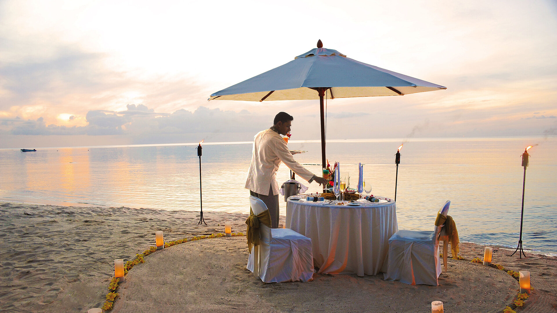 Private dining on the beach Romantic beach dinner at sunset at Maritim Hotel Mauritius