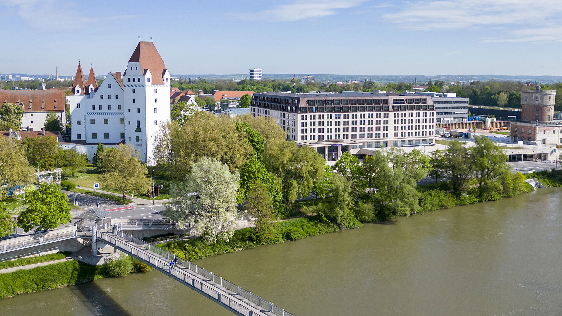 Exterior view Aerial view of Maritim Hotel Ingolstadt overlooking the Danube, a pedestrian bridge, and the historic castle.