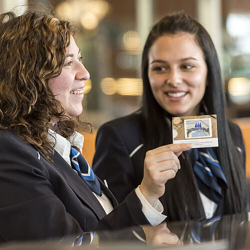 Check-in Smiling reception staff at Maritim Hotel Frankfurt presenting a room card.