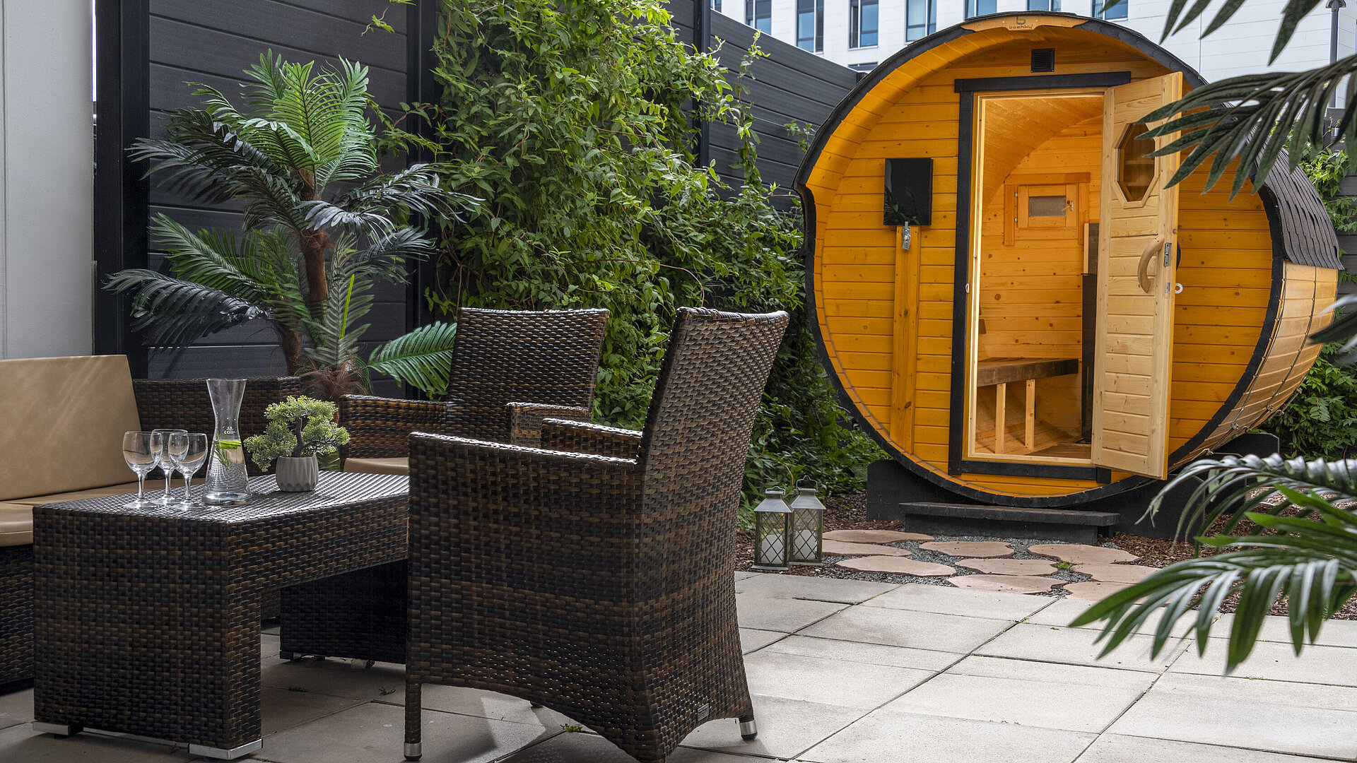 Sauna Cosy outdoor area with seating and barrel sauna at Maritim Hotel Travemünde