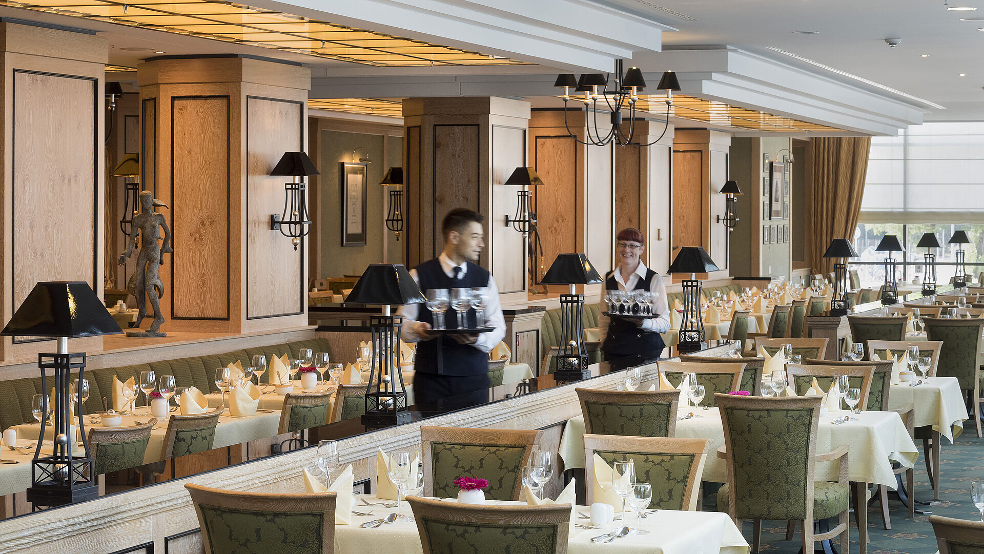 Restaurant 'Wintergarten' at Maritim Hotel Dresden with set tables and friendly staff.