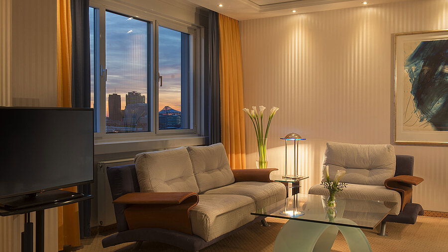 Area salotto con vista al tramonto nella Suite Kuckei del Maritim proArte Hotel Berlino.