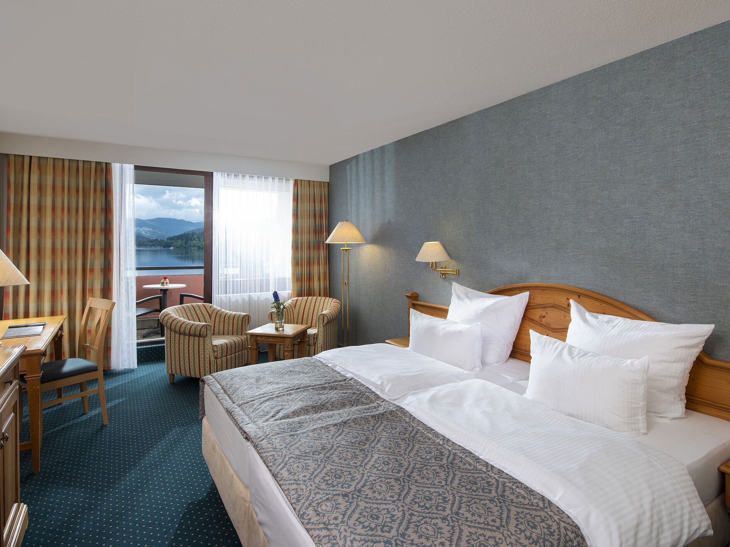 Spacious room at Maritim TitiseeHotel with seating area and view of Lake Titisee
