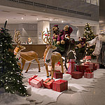 Festive decoration in the lobby of Maritim proArte Hotel Berlin with Santa Claus, reindeer, and gifts.