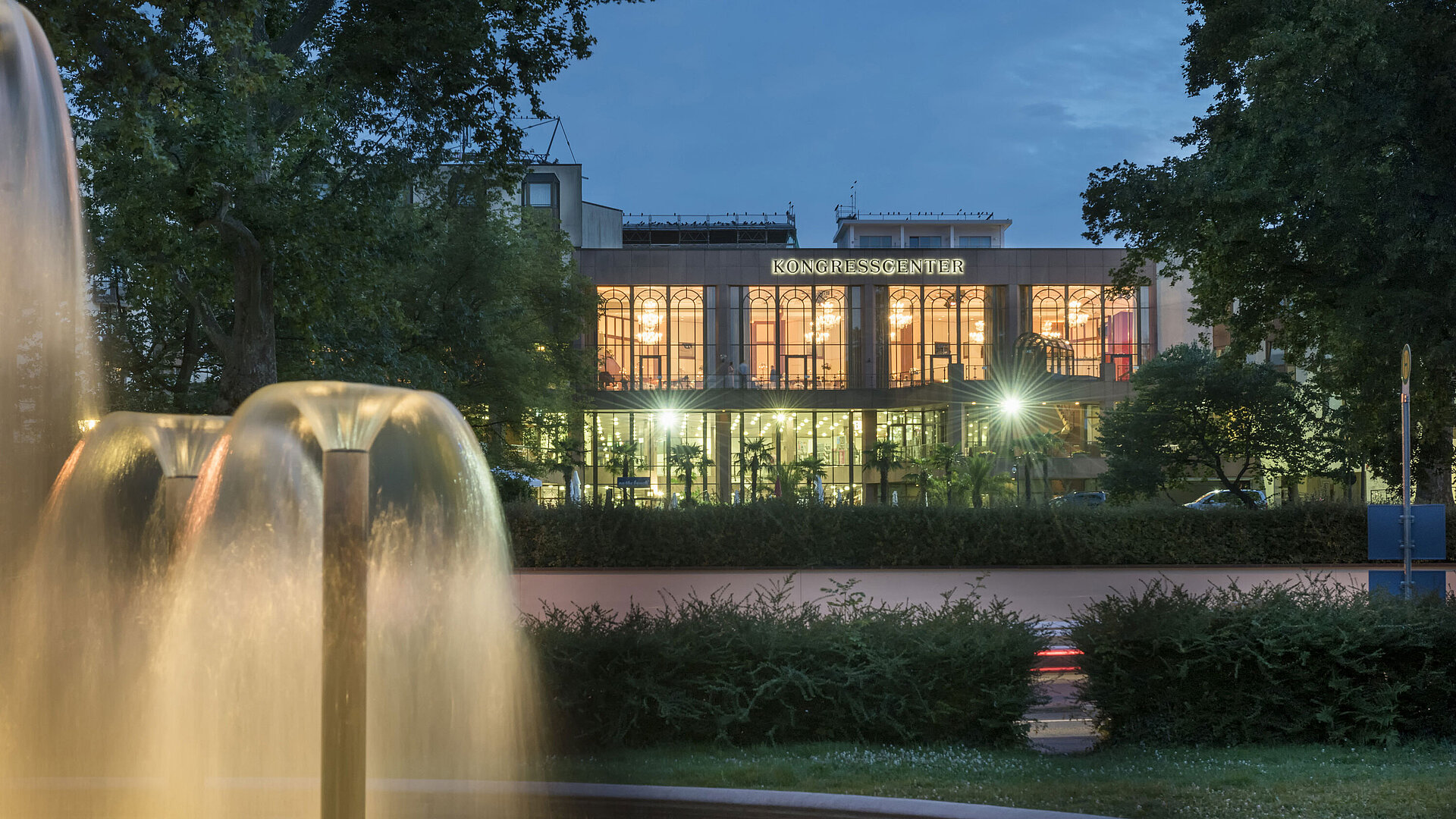 Atmospheric evening view of the congress center at Maritim Hotel Bad Homburg with illuminated fountain.