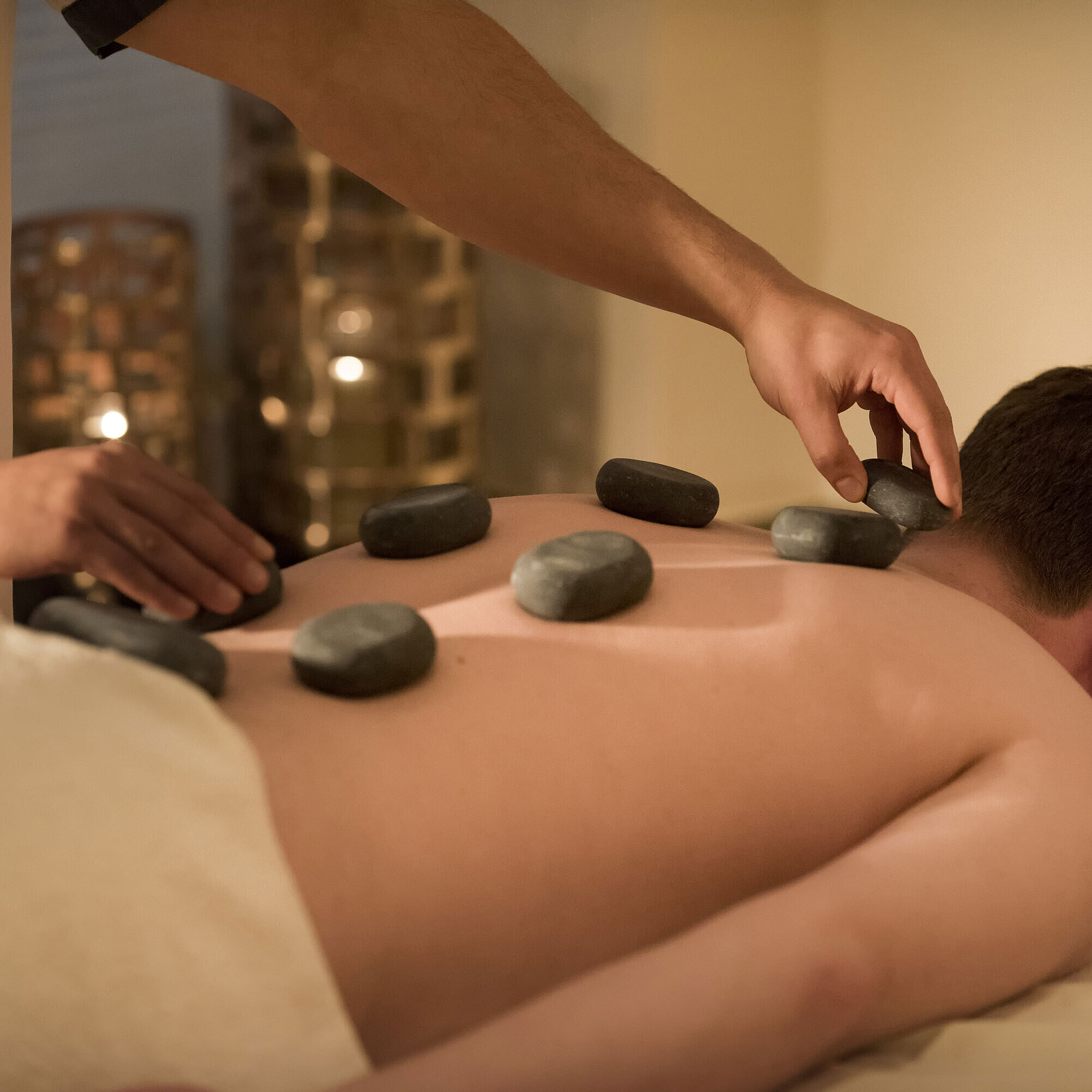 Massaggio con pietre calde per un relax profondo al centro benessere del Maritim Seehotel Timmendorfer Strand.