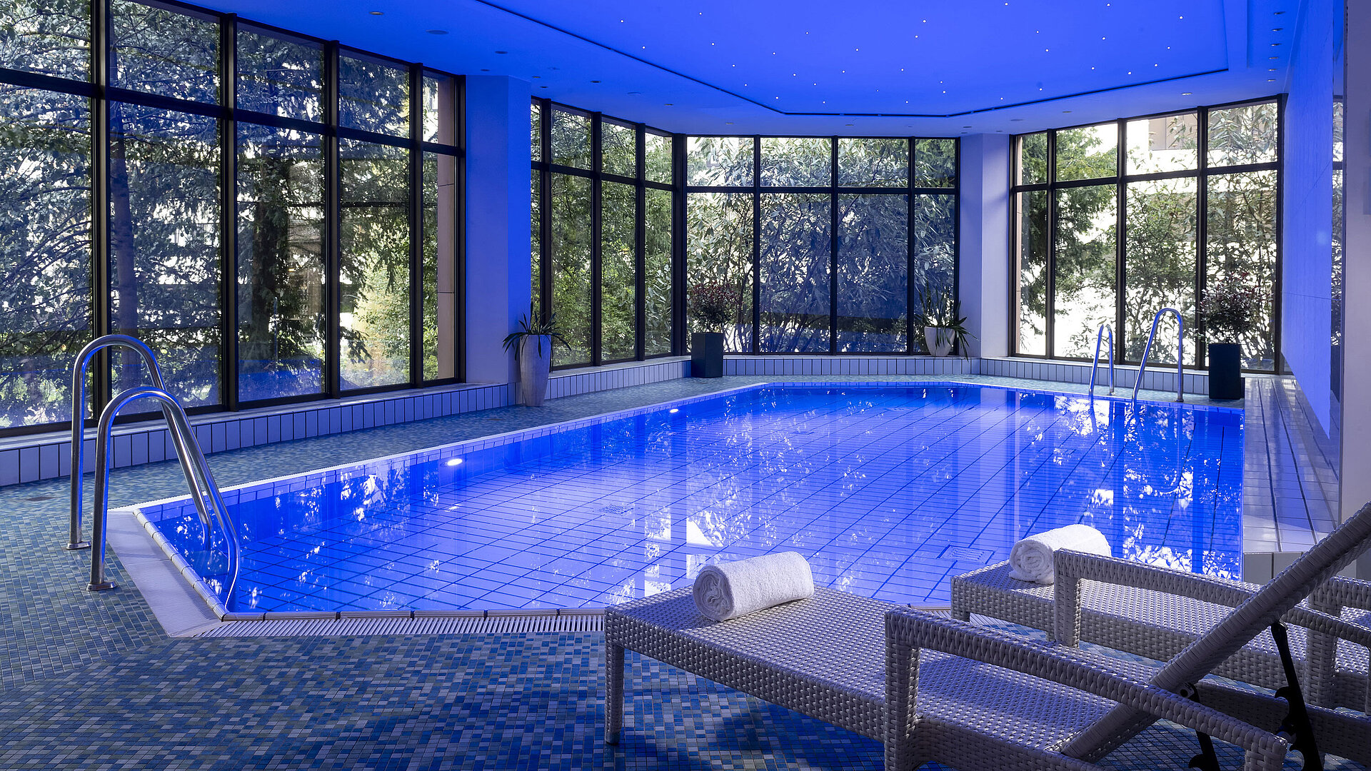 The stylish indoor pool at Maritim Hotel Bad Homburg offers a soothing ambiance with soft lighting and comfortable loungers.