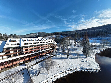 Maritim Hotel Titisee in winter with snow-covered garden and hotel by the lakeside