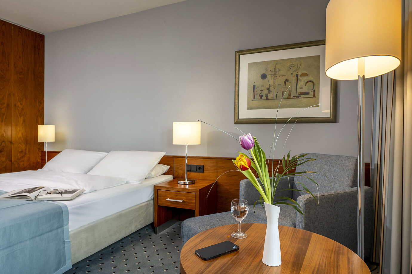 Habitación doble confort en el Hotel Maritim Darmstadt con decoración elegante, área de estar acogedora y toques modernos.