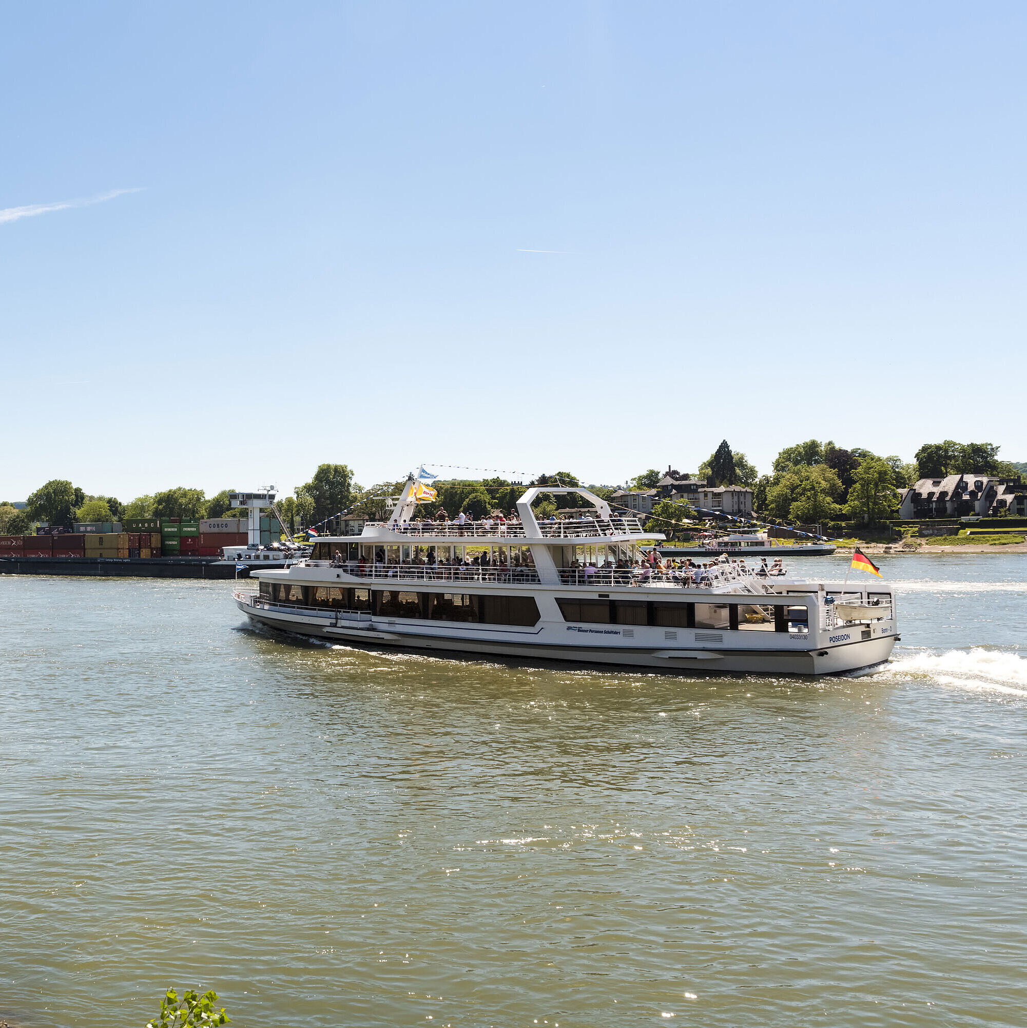 A sightseeing ship on the Rhine near Königswinter with a view of the picturesque landscape.