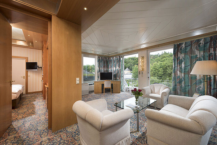 Spacious suite with lounge, bedroom, armchairs and view at Maritim Hotel Bad Wildungen