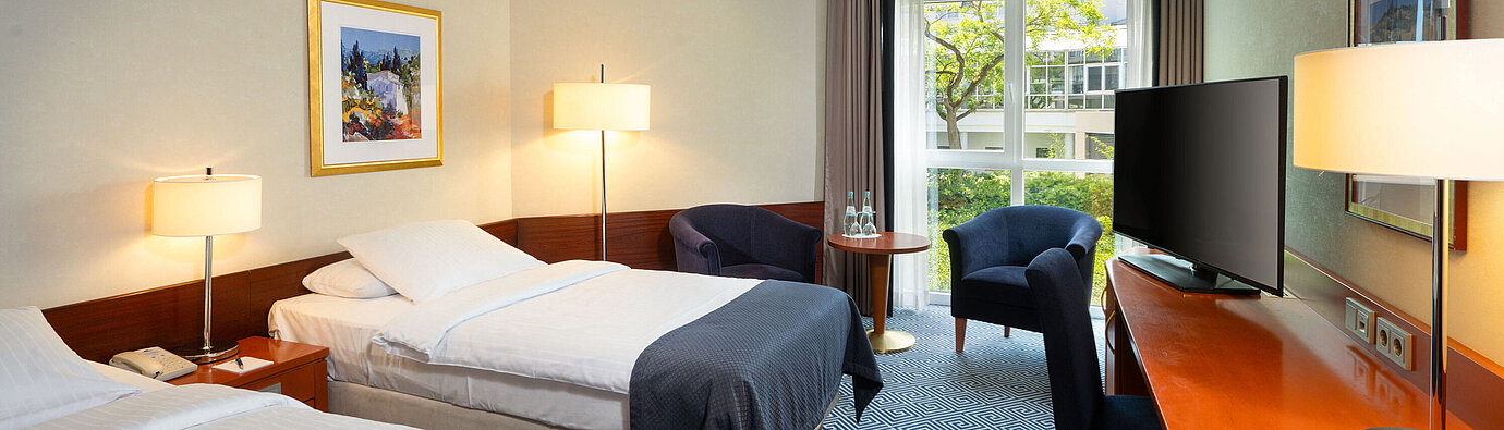 Classic Twin room at Maritim Hotel Würzburg with two single beds, desk and balcony