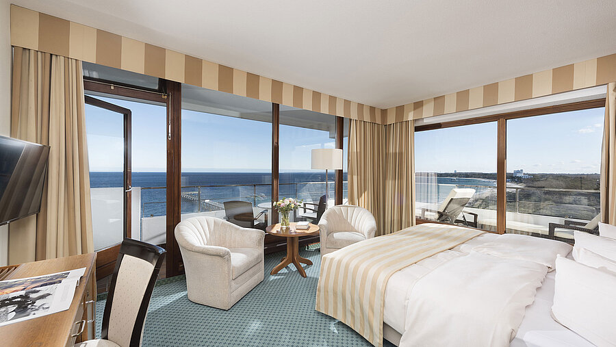 Superior room at Maritim Seehotel Timmendorfer Strand with sea view, balcony, seating area, and large bed.