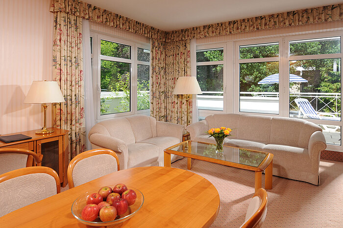 Bright living area of a suite at Maritim Hotel Bad Wildungen with access to the terrace