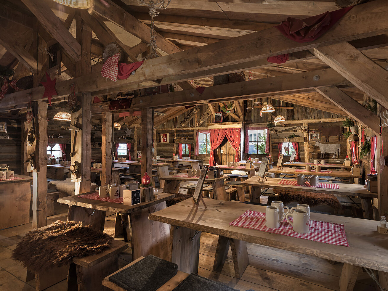 Warm interior with wooden tables, red curtains and rustic decor at Maritim Alm Stuttgart