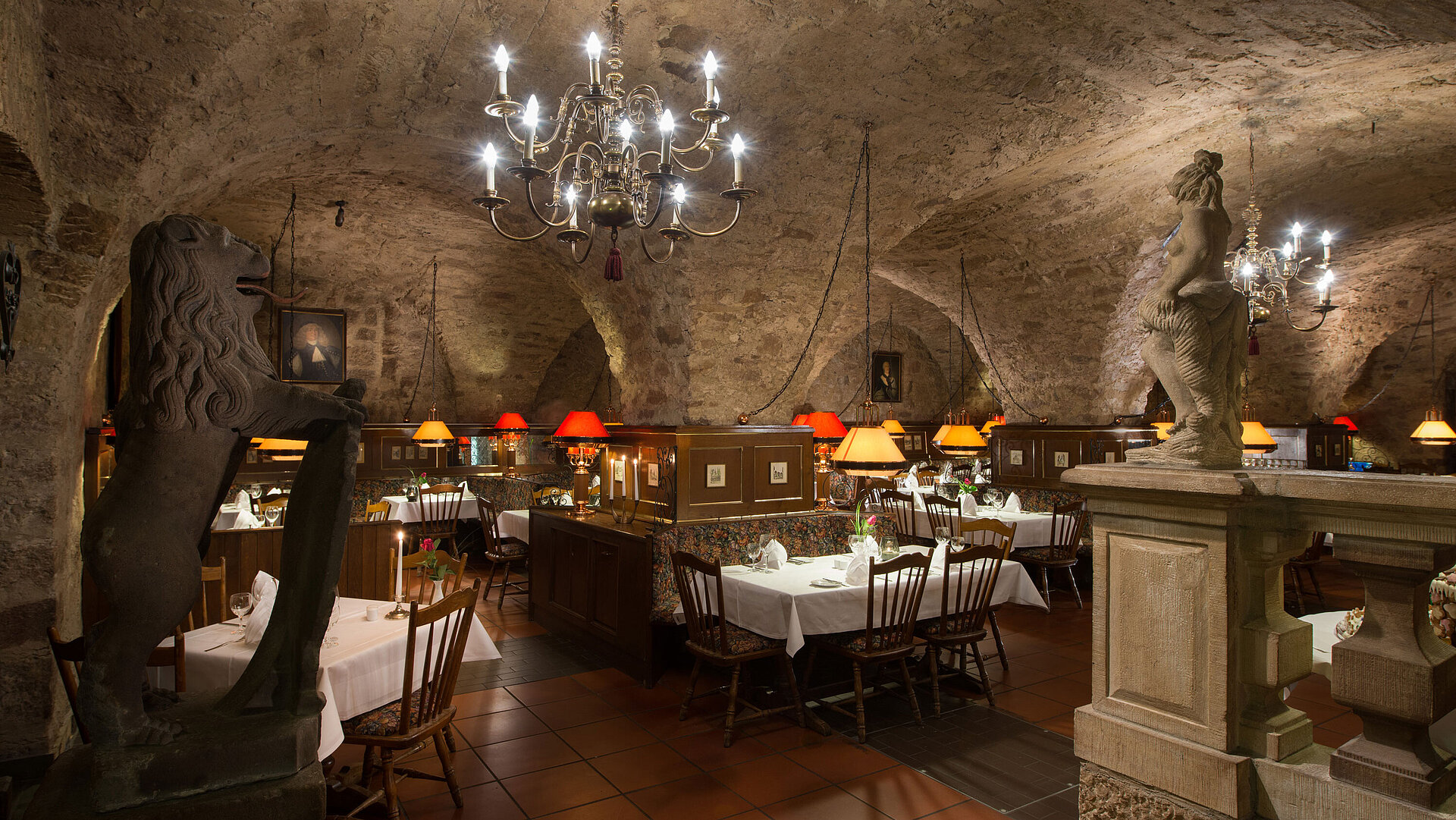 Historic restaurant at Maritim Hotel Fulda with vaulted ceiling, candlelight, and rustic ambiance.