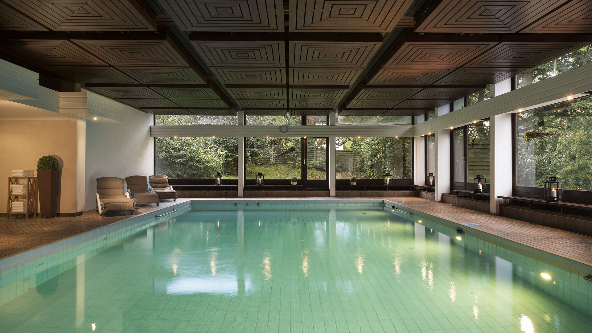 Bright indoor pool at Maritim Hotel Bad Salzuflen with large windows and view of the greenery