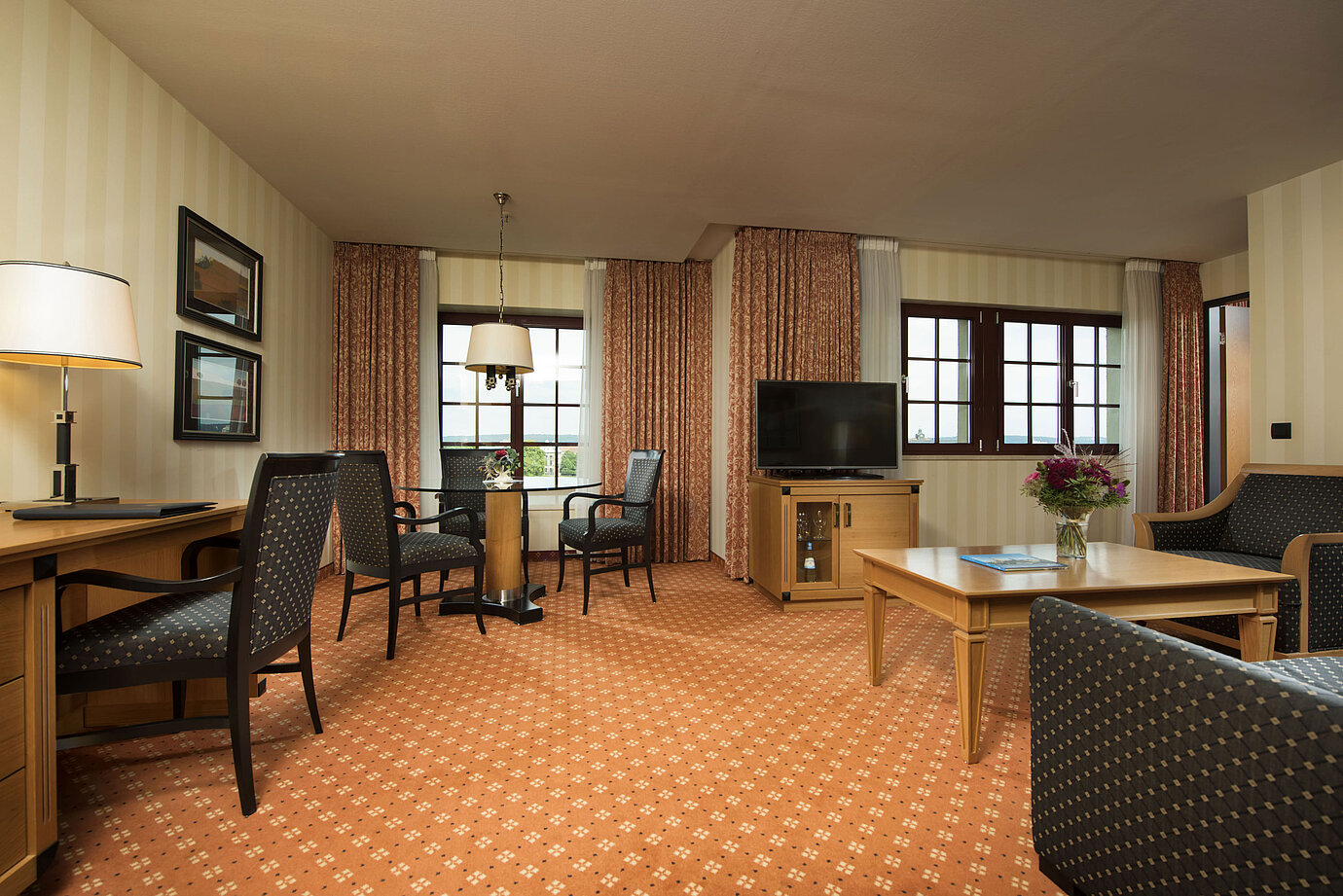 Junior Suite at Maritim Hotel Dresden with stylish seating area, large desk, and modern design.