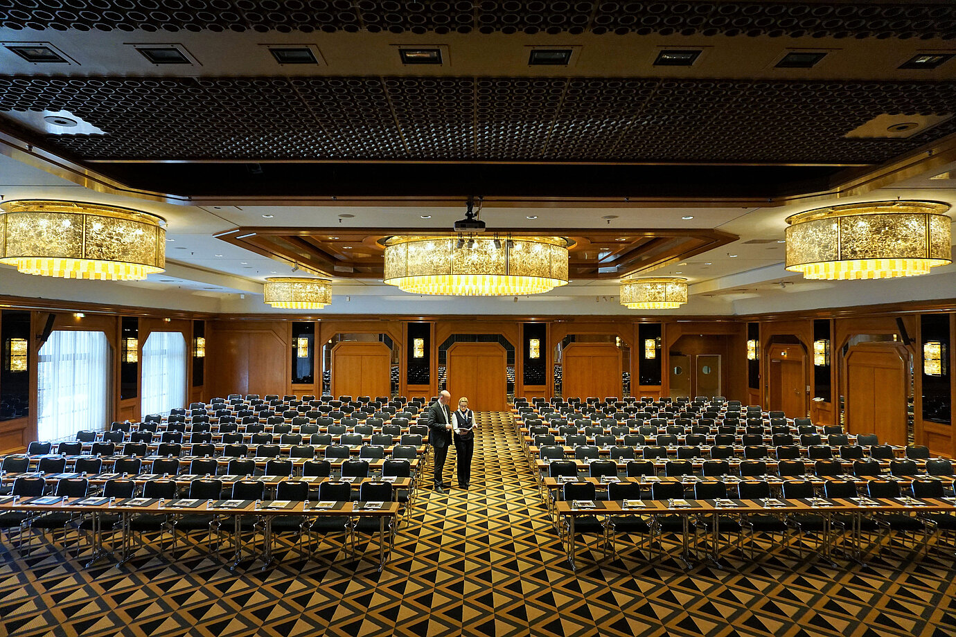 Salle de conférence élégante au Maritim Hotel Königswinter avec des sièges modernes et de magnifiques lustres.